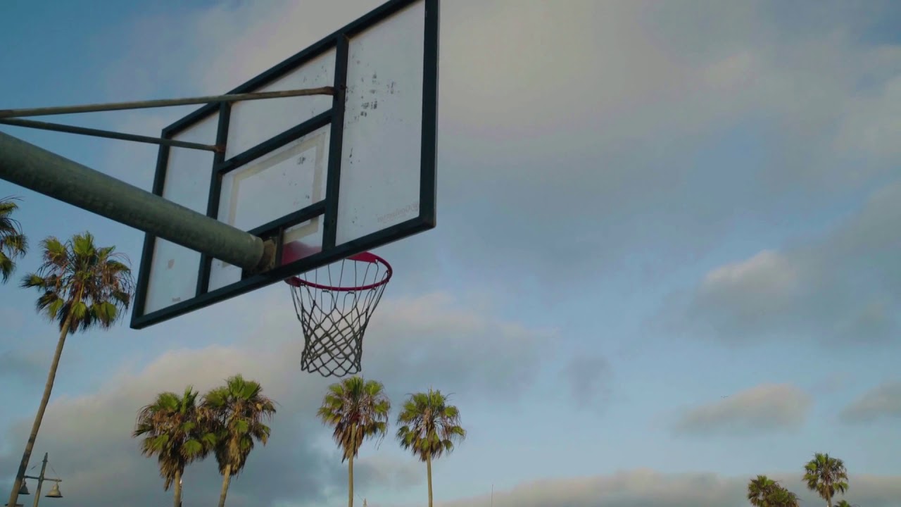 basketballs bounce off a hoop on a court at venice beach YouTube