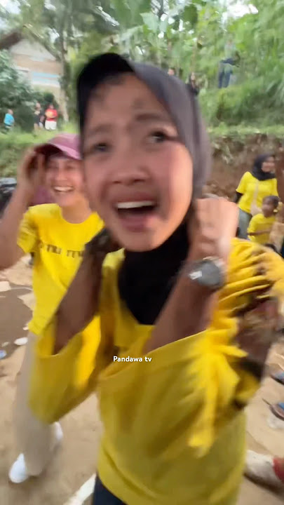 Two girls hugging, afraid of being hit by the hobby horse