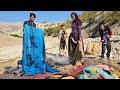 Nomads of iran washing blankets and carpets by the chavil family by the seasonal river