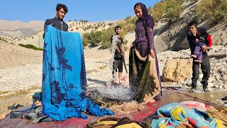 Nomads of Iran: washing blankets and carpets by the Chavil family by the seasonal river
