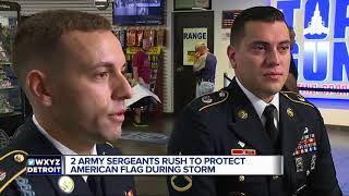 2 Army Sergeants rush to protect American flag during storm