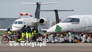 video: Over a hundred activists storm runway to block private jets