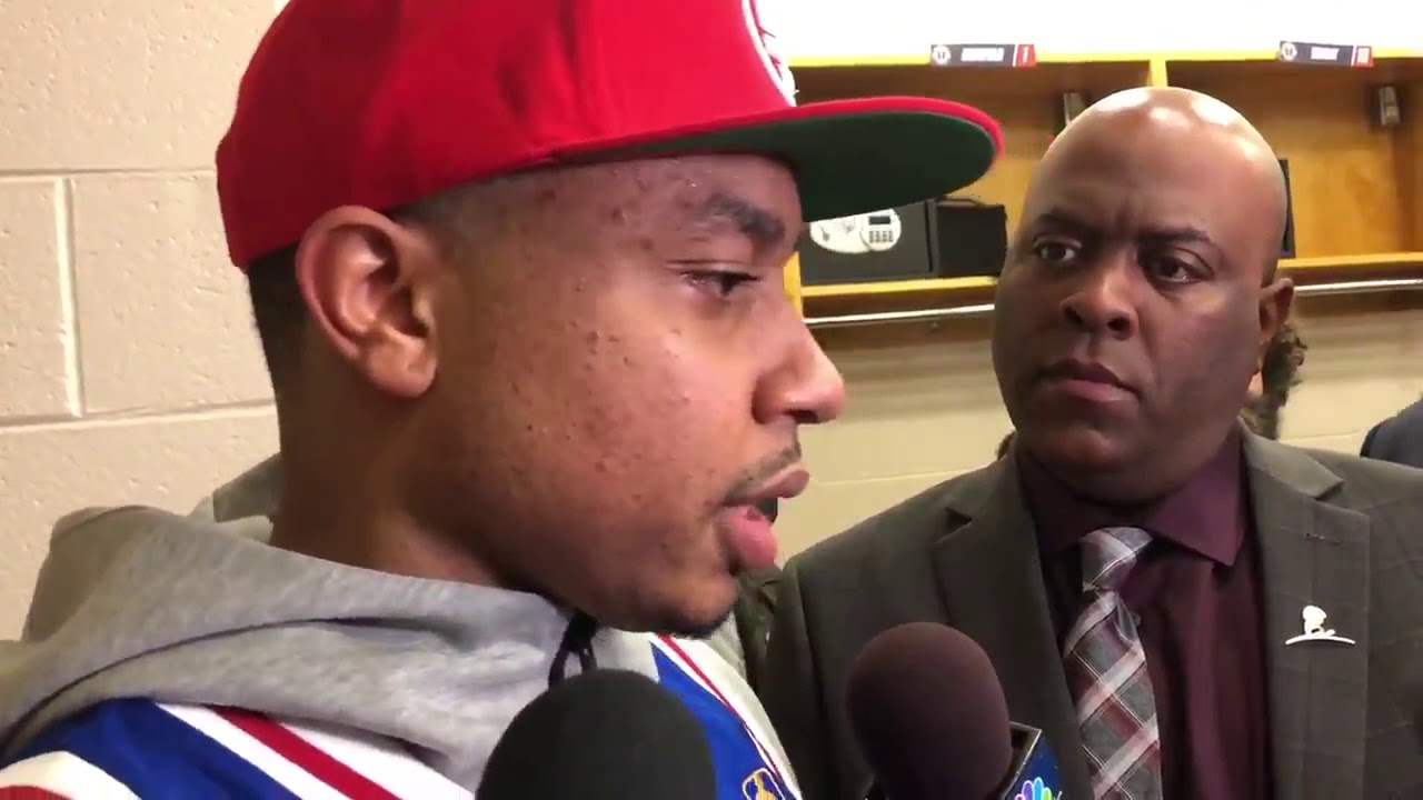 Isaiah Thomas, putting on an Iverson jersey, address reporters about entering stands