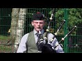 Piper Sandy Cameron playing 'Susan MacLeod' on bagpipes during 2021 Oban Games Argyllshire Gathering