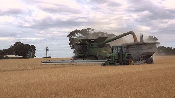 John Deere S680, harvesting wheat and unloading on the run.