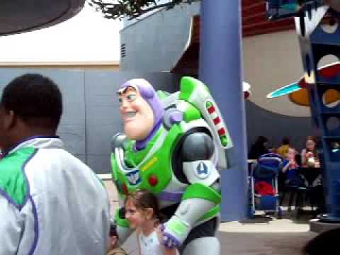 Buzz Lightyear of Star Command, co-star of the time-less Disney/Pixar ground-breaking classics Toy Story and Toy Story 2, an officially decorated & much celebrated Space Ranger from the Intergalactic Alliance, briefly hosting a Meet & Greet for some of his most appreciative Space Rangers-in-training and his other fans of all ages, before 'taking off' "To Infinity and Beyond...", generally stationed in the Gamma Quadrant of Sector 4, Buzz Lightyear is seen today on Earth between the Moonliner rocket (not shown) and the Innoventions exit (not shown) in Tomorrowland at Disneyland, featuring brief glimpses of the 'Giant Cosmic Wave-less Galactic Granite Imagineering Marble', and the exteriors of Space Mountain, Honey I Shrunk the Audience and Redd Rocketts Pizza Port, Lve Snd, Daytime, a Disney/Pixar Animated Character Live Meet & Greet CLIP, filmed on 04/14/09...