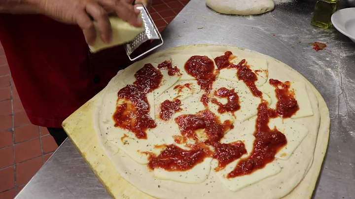 Metro Pizza's John Arena makes pizza with dough, s...