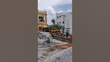 JCB 2DX loading front bucket for filling columns of the building.