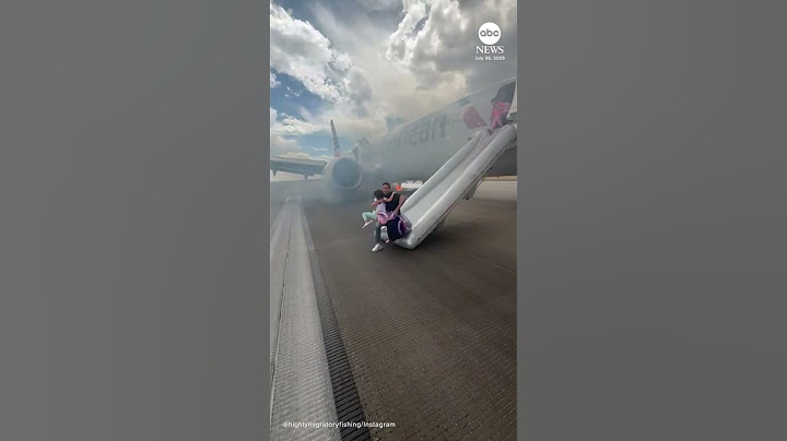 Passengers exit plane via emergency slide after aborted takeoff