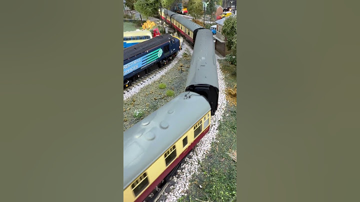 Crossing the country road Hornby TTS "Duke of Gloucester" pulling cream and crimson coaches.