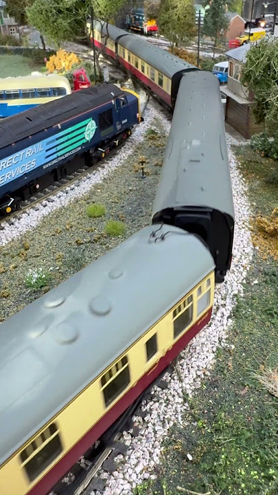 Crossing the country road Hornby TTS 'Duke of Gloucester' pulling cream and crimson coaches.
