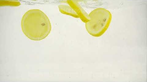 Lemon slices fall into the water, slow motion close-up