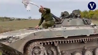 A Russian tank with a white flag surrenders to the Ukranian soldiers