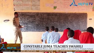 A brave Kenya Defense Forces(KDF) officer teaches pupils at Khorof-Harar Primary School