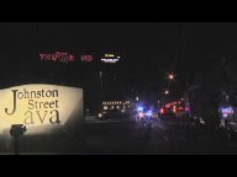 A gunman sitting in a packed movie theater stood up about 20 minutes into the showing of "Trainwreck