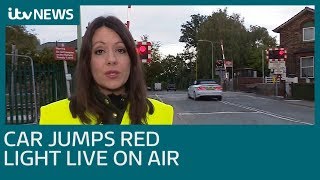 Car jumps red light at level crossing live on air | ITV News screenshot 2