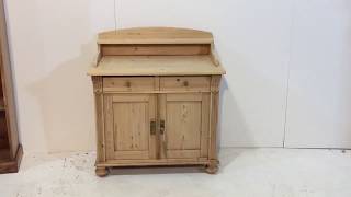 A small old pine dresser base with 2 drawers above 2 doors, and a shelf inside. With a 