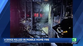 Woman injured, four dogs die after fire at mobile home in Oakdale