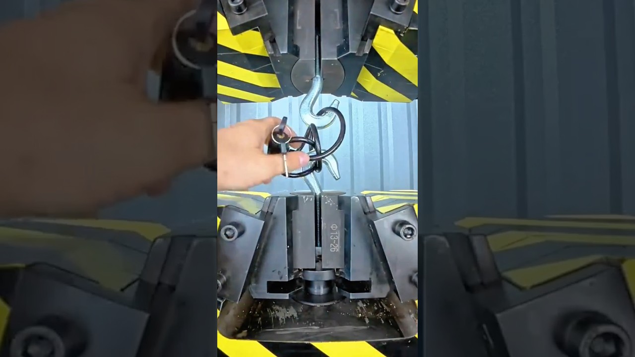 Heavy duty hydraulic press crushing a steel hook lock