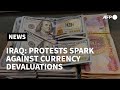 Iraqis protest after currency value slashed | AFP