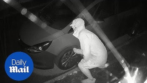 Covered man slashes car tyres in what is thought to be a vendetta