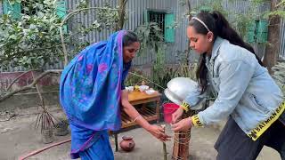 Grandmother Making winder cake for her grandson in the rural area of Bangladesh .