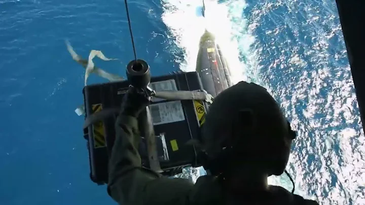 U.S. Marine Corps MV-22B Osprey resupplies U.S. Navy Submarine