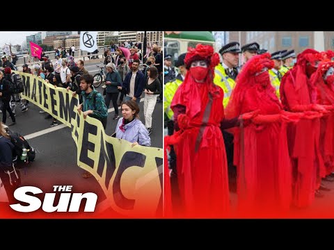 Extinction Rebellion protesters BLOCK London Bridge with Bus as eco-warriors lie in road.