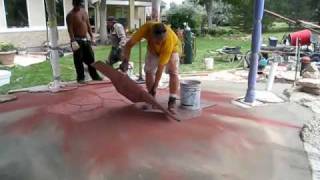 Stamping Concrete. The pour is 4 inches thick, with 1/2 inch rebar on 24 inch centers. Adobe Buff hardener is applied when the 
