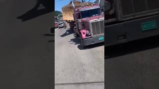 May Pen Clarendon See overloaded truck navigate traffic.