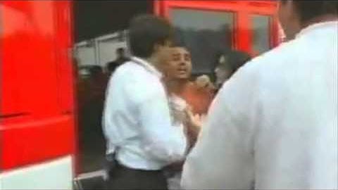 Coulthard imitates Montoya after being hit by a camera