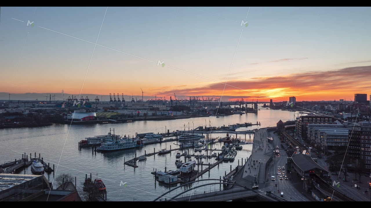 Beautiful Hamburg, Germany during Golden Hour Sunset with Red Sky and View of Boats in River and