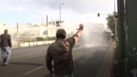 Greek police fire water cannon at rally attendees