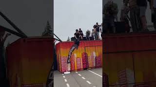 Scooter rider jumps off orange and yellow shipping container and faceplants