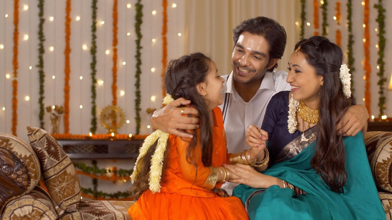 South Indian Family - Attractive parents happily enjoying Diwa