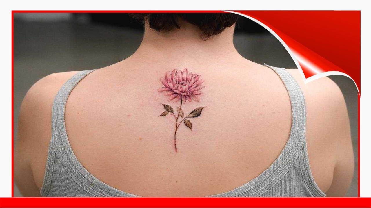 Fine line chrysanthemum flower tattooed on the bicep.