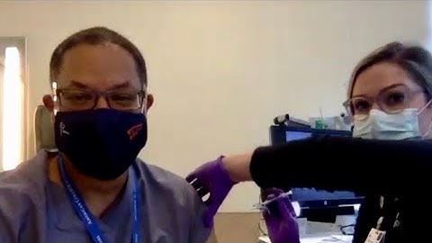 Coronavirus vaccine: University of Virginia physician receives COVID-19 vaccine injection