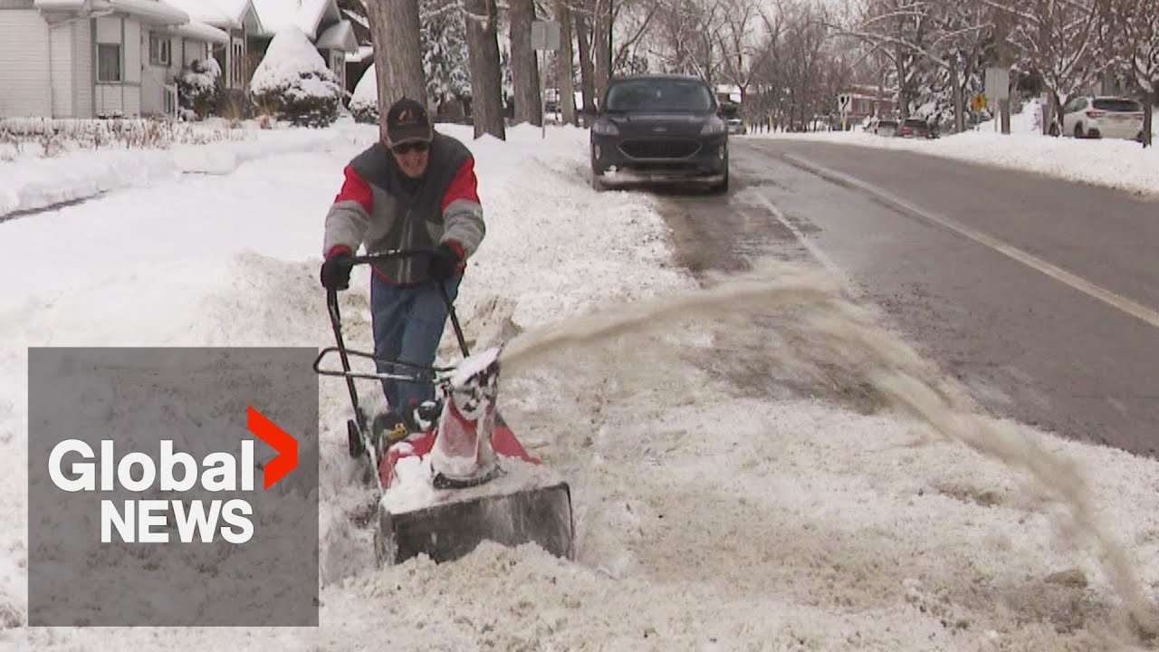 Calgarians dig out after spring storm brings over 20 cm of snow - YouTube