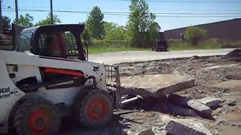 Bob Cat Loading a Dump Truck With  Concreat