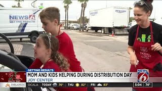 Mom and children help during Angel Tree distribution day