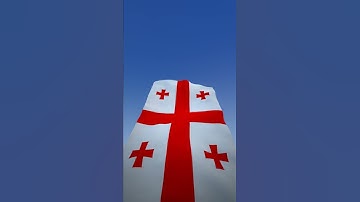 Georgia flag waving over blue sky