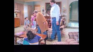 Dan Connor chuckles when he gets picked up off the ground by his dad in this Roseanne episode