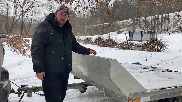 Loading and unloading snowmobile on tilt trailer