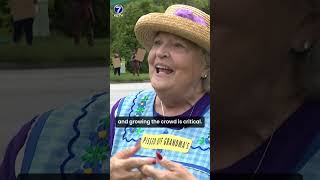 Dozens of people hold "Workers Over Billionaires" rally and march in Omaha