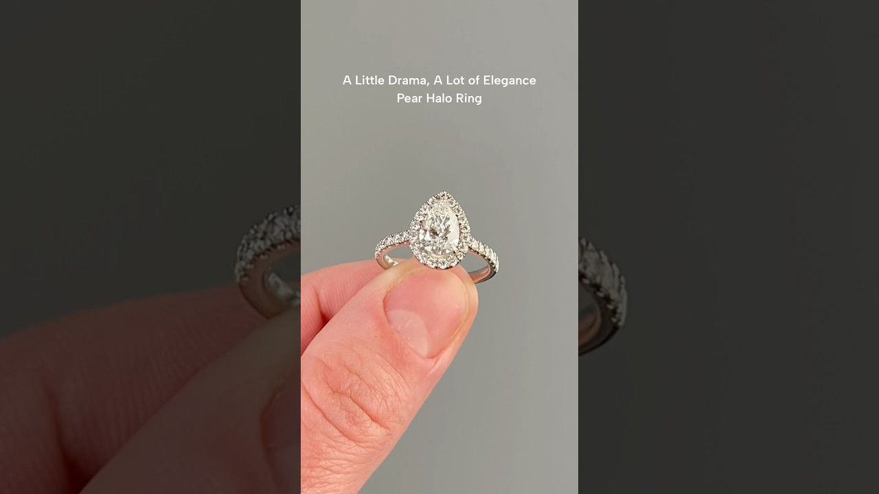 Perfect blend of sparkle and sophistication:Pear shape centre stone in a halo with diamond shoulders
