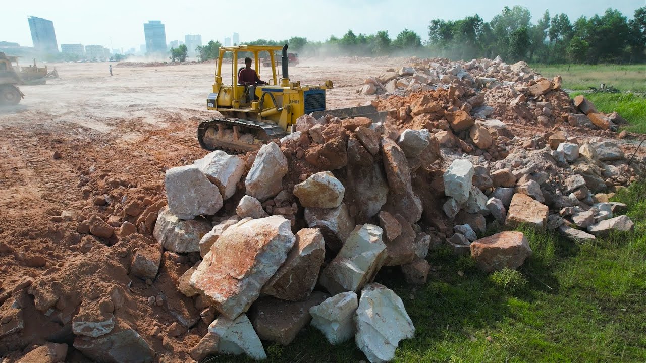 The incredible action bulldozer moving rock stone clearing ground level ...