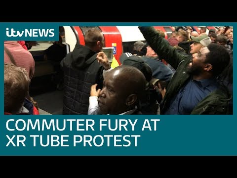 Commuters drag Extinction Rebellion protesters off Tube trains | ITV News