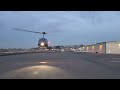 Enstrom 280FX helicopter landing Oceanside Airport night.