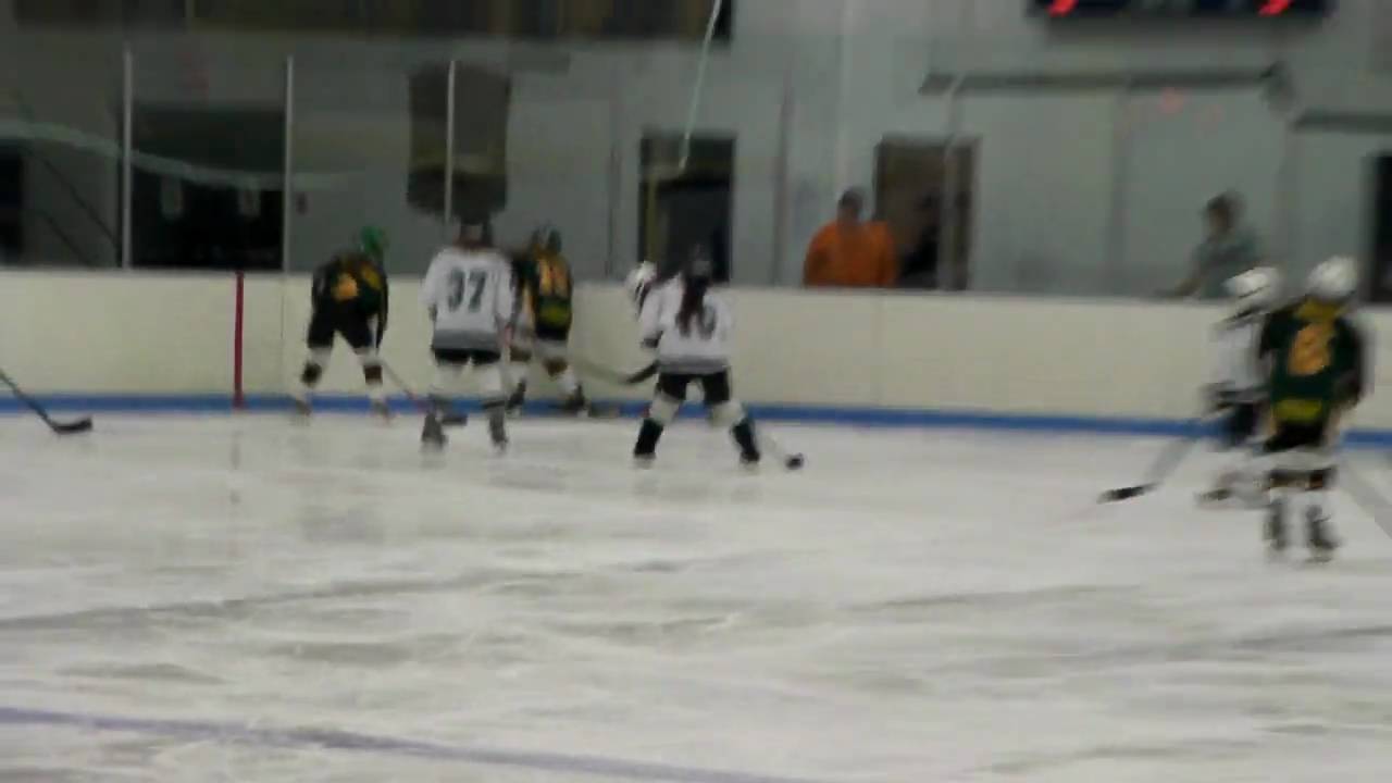 Hamden Girls Hockey player Emma Smyth looking in front for teammate Emily Gotowala
