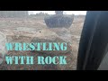 Moving large rock with excavator